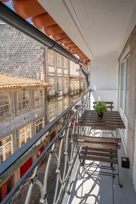 a balcony with a bench and a bike at The Medievel in Porto
