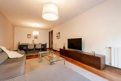 a living room with a couch and a flat screen tv at Premium Flat w/ Pool, Gym & Garage by HostWise in Vila Nova de Gaia