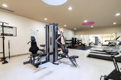 a gym with treadmills and elliptical machines at Premium Flat w/ Pool, Gym & Garage by HostWise in Vila Nova de Gaia