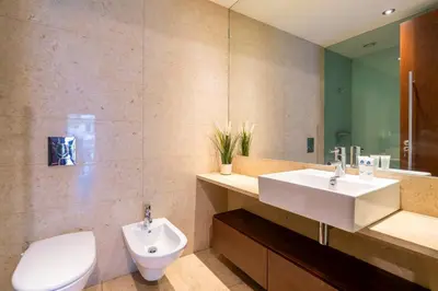 a bathroom with a sink and a toilet at Premium Flat w/ Pool, Gym & Garage by HostWise in Vila Nova de Gaia