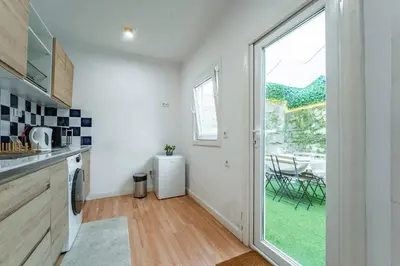 a kitchen with a large glass door leading to a yard at Oporto Maria Pia Apartment Whith Terrace 2 in Porto