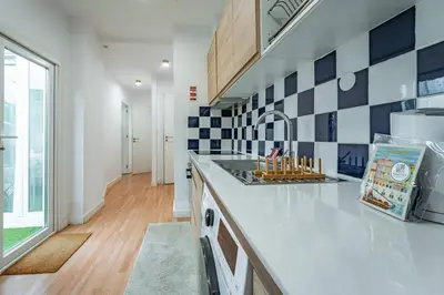 a kitchen with blue and white tiles on the wall at Oporto Maria Pia Apartment Whith Terrace 2 in Porto