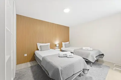 a room with two beds in a room at GuestReady - Modern Porto's retreat in Porto