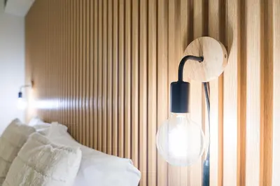 a lamp hanging on a wall next to a bed at GuestReady - Modern Porto's retreat in Porto