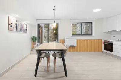 a kitchen with a wooden table and chairs at GuestReady - Modern Porto's retreat in Porto