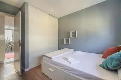 a bedroom with a large bed and a closet at Your Home at Porto in Porto