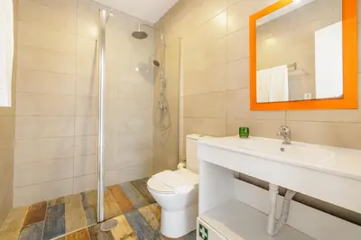 a bathroom with a toilet and a sink and a shower at Your Home at Porto in Porto