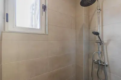 a bathroom with a shower with a shower head at Your Home at Porto in Porto