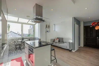 a kitchen and living room with a couch and a table at Your Home at Porto in Porto