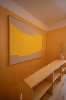 a painting on a wall above a wooden shelf at Belmont Riverside 5m in Porto