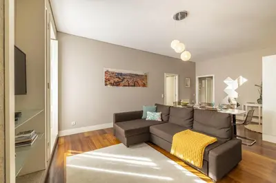 a living room with a couch and a table at Cardosas Square Living in Porto