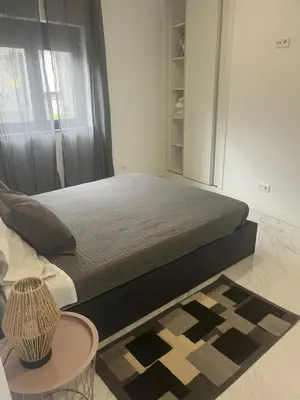 a bedroom with a bed and a table in a room at Candal house in Vila Nova de Gaia