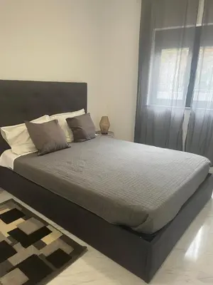 a large bed in a bedroom with a window at Candal house in Vila Nova de Gaia
