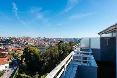 a view of a city from the balcony of a building at NEW! The Porto Wine Cellars Penthouse in Vila Nova de Gaia