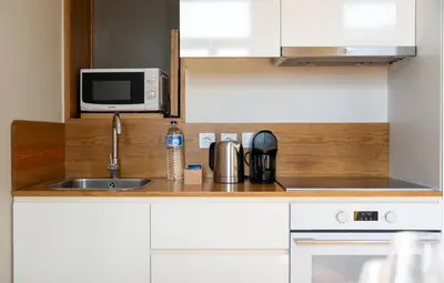 a kitchen with a sink and a microwave at NEW! Blue Pearl Apartment in Porto