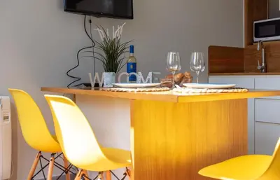 a kitchen with a table with yellow chairs at NEW! Blue Pearl Apartment in Porto