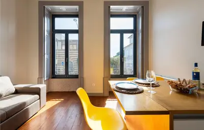 a living room with a couch and a table at NEW! Blue Pearl Apartment in Porto