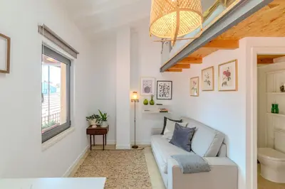 a living room with a couch and a window at VIVA Fontainhas Houses in Porto