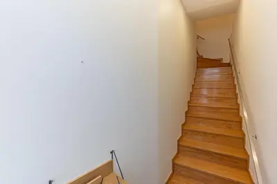 a staircase in a house with wooden floors and white walls at GuestReady - Porto stay with homely touches in Porto