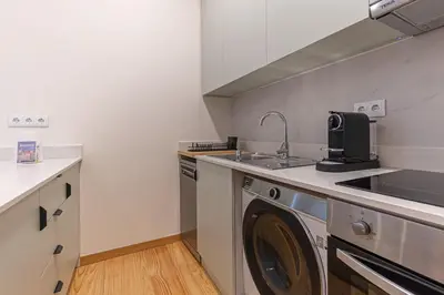 a kitchen with a sink and a washing machine at GuestReady - Porto stay with homely touches in Porto