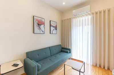 a living room with a blue couch and a table at GuestReady - Porto stay with homely touches in Porto
