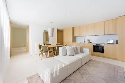 a living room with a white couch and a table at GuestReady - DPV GuestHouse - Apart 6 in Porto