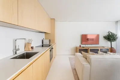 a kitchen with a sink and a couch at GuestReady - DPV GuestHouse - Apart 6 in Porto