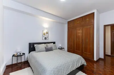 a bedroom with a bed and a wooden cabinet at Home Sweet Home in Porto