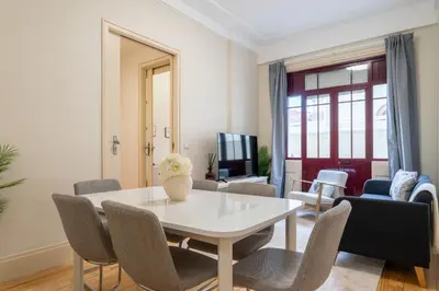 a living room with a white table and chairs at Modern & Cozy Flat with Workspace by HostWise in Porto