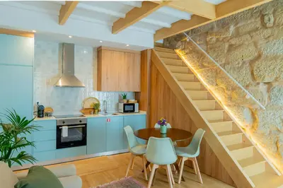 a kitchen with a staircase and a table and chairs at VIVA Boavista Duplex Retreat in Porto