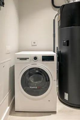 a white kitchen with a sink and a microwave at Land Roots Riverside Apartments in Vila Nova de Gaia
