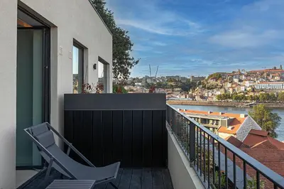 a living room with a couch and a table at Land Roots Riverside Apartments in Vila Nova de Gaia