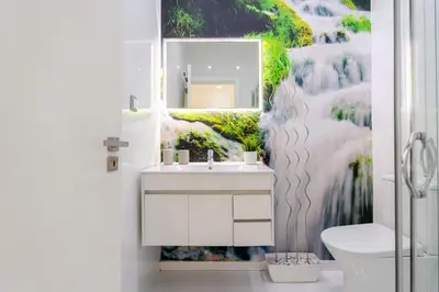 a bathroom with a sink and a mirror at Sleek Apartment with Balcony by HostWise in Porto