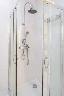 a shower with a clear glass shower stall at Sleek Apartment with Balcony by HostWise in Porto