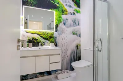 a bathroom with a sink and a mirror at Sleek Apartment with Balcony by HostWise in Porto