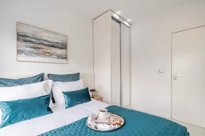 a bedroom with a bed with blue pillows at Sleek Apartment with Balcony by HostWise in Porto