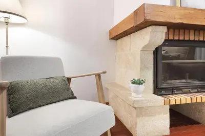 a living room with a chair and a fireplace at ON Apartments - Family Retreat in Porto