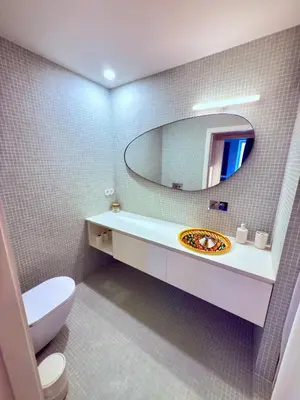 a bathroom with a white toilet and a mirror at Esmeralda Porto in Porto