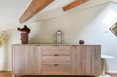a wooden dresser in a room with a ceiling at Cosy HouseTypical Space in Porto by Su e Luís in Porto