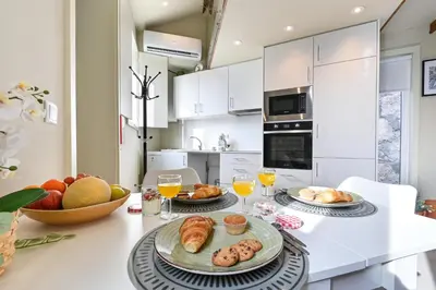 a kitchen with two plates of food on a table at Cosy HouseTypical Space in Porto by Su e Luís in Porto