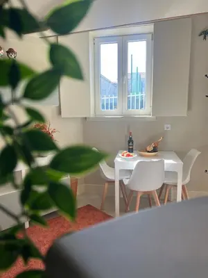 a kitchen with a table and chairs and a window at Cosy HouseTypical Space in Porto by Su e Luís in Porto