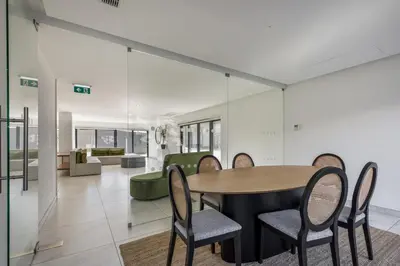 a dining room and living room with a table and chairs at Antas Park with pool and gym - to work & leisure in Porto