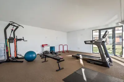 a gym with several treadmills and exercise bikes at Antas Park with pool and gym - to work & leisure in Porto