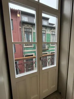 an open door with two windows and a balcony at Pinheiro Houses's- Luxury Apartment's by Oporto Soul in Porto