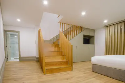 a bedroom with a staircase and a bed at Pinheiro Houses's- Luxury Apartment's by Oporto Soul in Porto