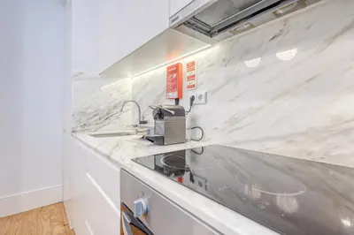 a kitchen with a counter top with a sink at OPORTO GUEST São Brás 66 in Porto
