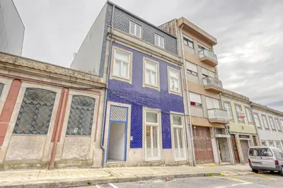 an old blue building on a city street at OPORTO GUEST São Brás 66 in Porto