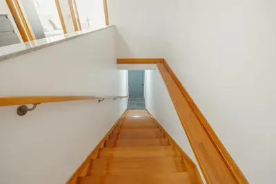 a staircase in a house with white walls and wooden floors at Modern Terrace 2BD Apartment by Vacationy in Porto