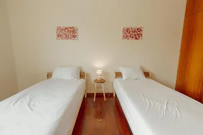 two beds sitting next to each other in a room at Botanic Garden Terrace Apartment by Vacationy in Porto