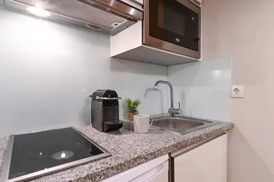 a kitchen counter with a sink and a microwave at ON Apartments - Free Parking & Pet Friendly in Porto